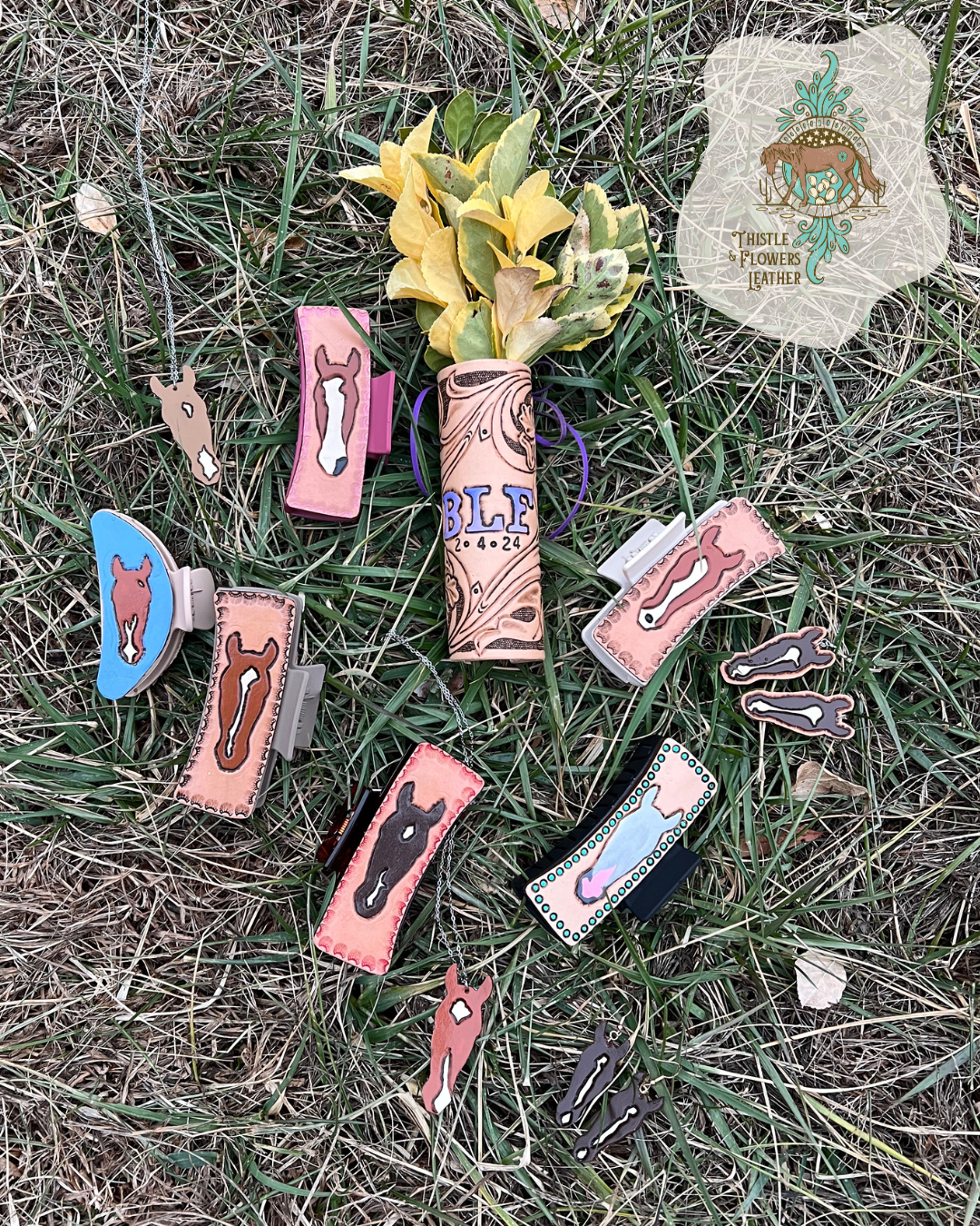 Custom horse hair clips in grass with a bouget wrap, custom horse necklaces, and custom horse earrings. Thistle and FLowers Leather logo is in the top right corner.