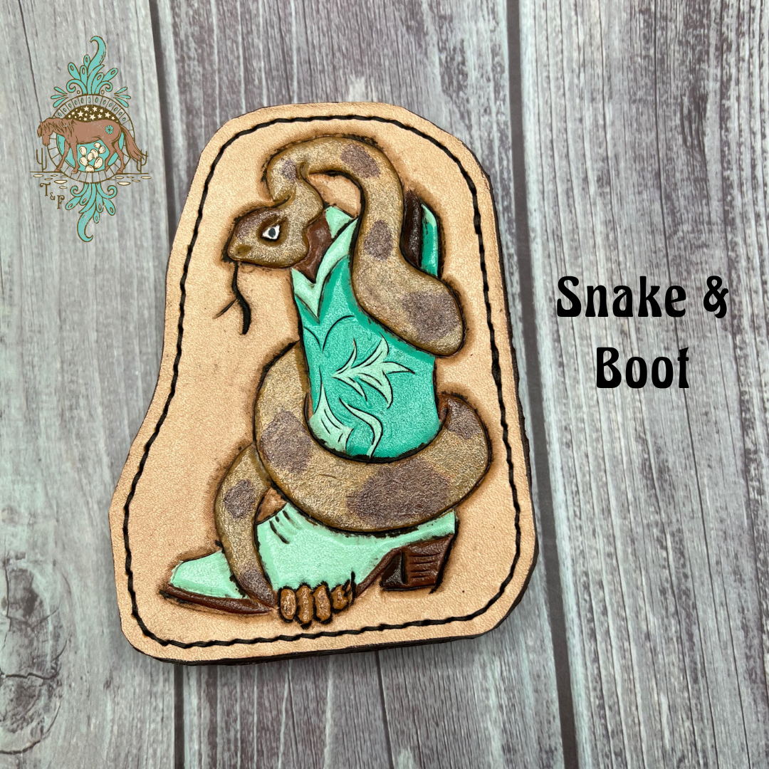 Tooled leather all weather bag charm with a tooled and painted snake wrapped around a mint green boot. Snake is painted to look like a diamondback rattlesnake. 