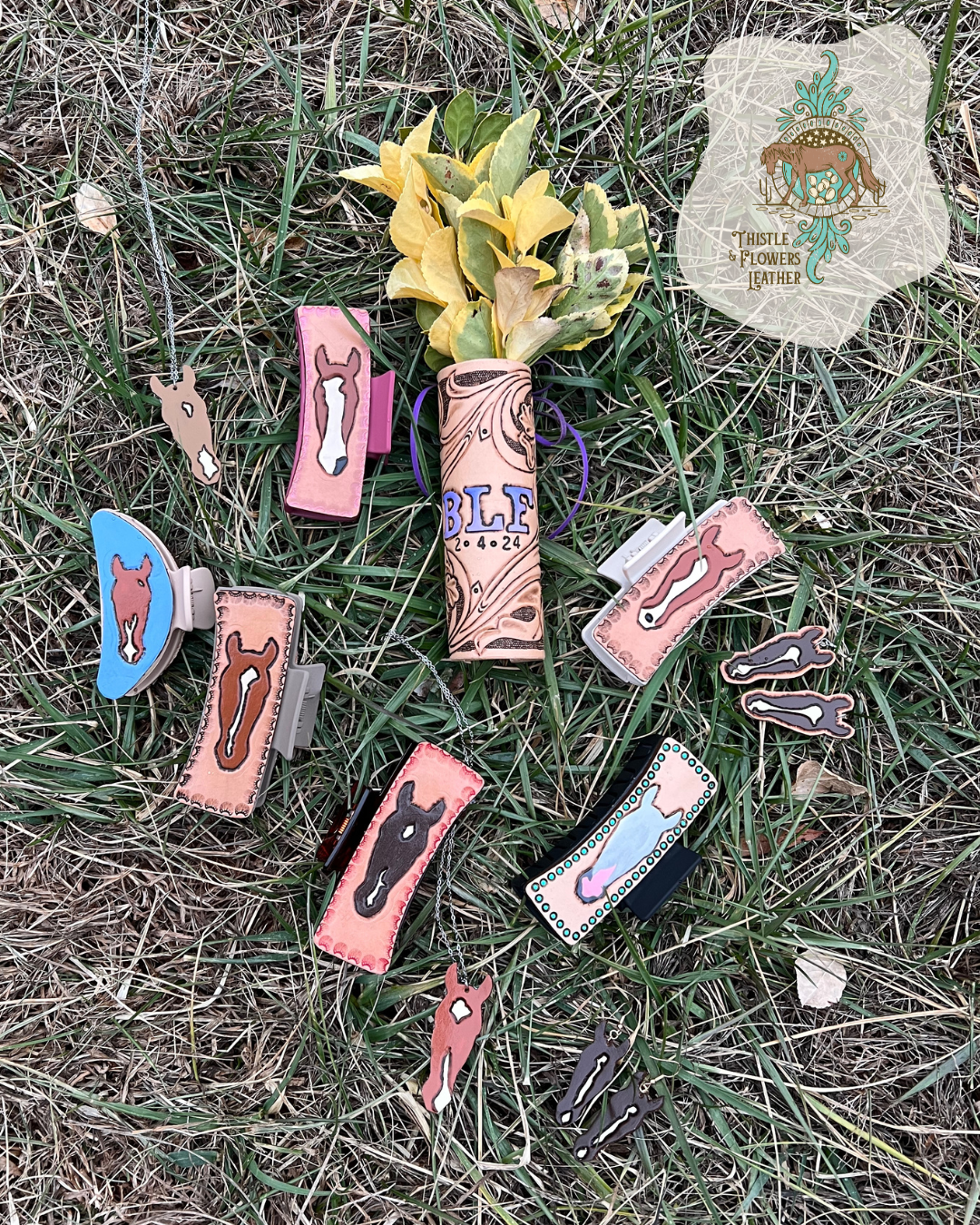 Custom horse hair clips in grass with a bouget wrap, custom horse necklaces, and custom horse earrings. Thistle and FLowers Leather logo is in the top right corner. 